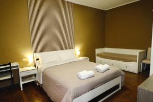 a bedroom with a bed with two towels on it at Bergamoincity in Bergamo +10 photos