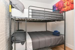 a couple of bunk beds in a room at Chic 2BR Stay-Steps From Central Park in New York