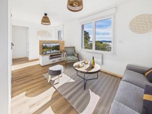 a living room with a couch and a tv at Les Roches d'Argent & Beg Douar in Plestin-les-Grèves