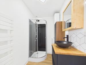 a bathroom with a sink and a glass shower at Les Roches d'Argent & Beg Douar in Plestin-les-Grèves +20 photos