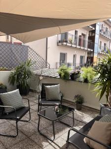 a patio with chairs and a table on a balcony at Alba in Fiore in Alba