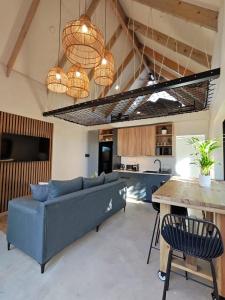 a living room with a couch and a table at Ocean Whisper Beach Villas in Jeffreys Bay