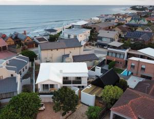 an aerial view of a town with houses and the ocean at Ocean Whisper Beach Villas in Jeffreys Bay