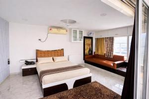 a bedroom with a bed and a couch in it at Shri krishna paradise in Panvel
