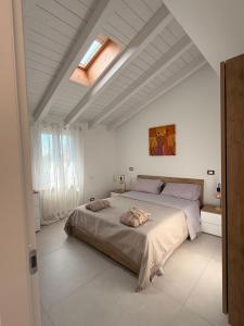 a bedroom with a large bed in a white room at Oasi del Po in Monticelli dʼOngina +37 photos