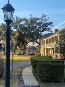 a street light in front of a large building at Ormond Manor in Destrehan