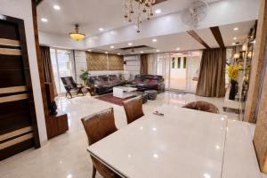 a living room with a white table and chairs at Shri krishna paradise in Panvel +22 photos