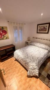 a bedroom with a bed and a wooden floor at La Morada del Jucar in Cuenca