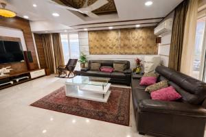 a living room with a leather couch and a coffee table at Shri krishna paradise in Panvel