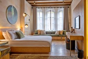 a bedroom with a large bed and a couch at Mare Cappadocia Adults Only in Göreme +146 photos