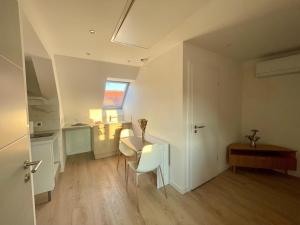 a small room with a table and a kitchen at - Le 4ème Tourbillon- in Molsheim