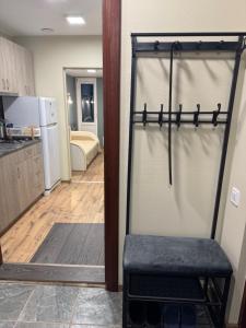 a view of a kitchen and a room with a stool at Lielupes Apartments Jurmala in Jūrmala