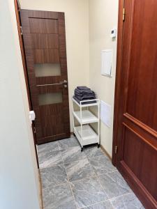 a hallway with a door and a towel rack at Lielupes Apartments Jurmala in Jūrmala +50 photos