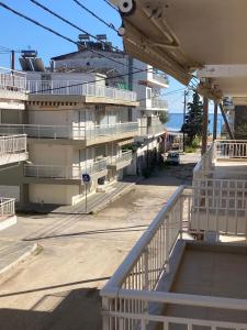 a building with white balconies next to the ocean at La casa di Zoe in Flogita