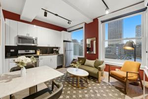 a kitchen and living room with a table and chairs at The Plymouth Chicago in Chicago