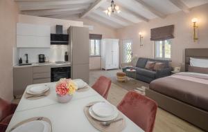 a kitchen and living room with a bed and a table at Villa Fiore di san Antonio in Rovinj