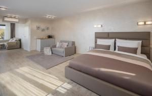 a bedroom with a large bed and a living room at Villa Fiore di san Antonio in Rovinj
