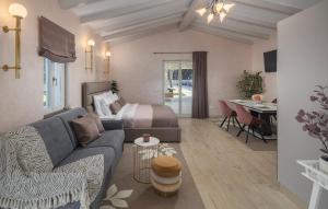 a living room with a couch and a bed at Villa Fiore di san Antonio in Rovinj