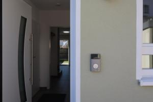 a hallway of a building with a lightswitch on the wall at Ferienhaus Ferati - Modernes Neubau-Haus & nahe Legoland in Günzburg