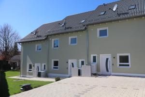 a large white house with a lot of windows at Ferienhaus Ferati - Modernes Neubau-Haus & nahe Legoland in Günzburg