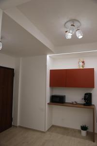a room with a kitchen with a shelf and lights at B&B Le Eolie in Milazzo