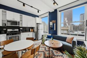 a living room with a couch and a table at The Plymouth Chicago in Chicago +56 photos
