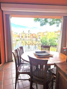a dining room with a table and chairs and a large window at Port Chambly Waterside Villa in Terre Rouge