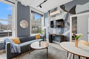 a living room with a couch and a table at The Plymouth Chicago in Chicago