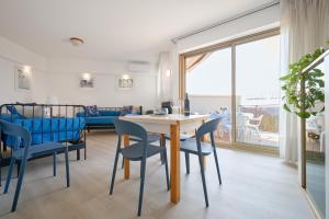 a living room with a table and chairs and a couch at Residenze Etruria in San Vincenzo