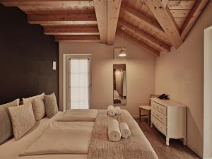 a bedroom with a large bed with towels on it at Guesthouse Odle in Funes
