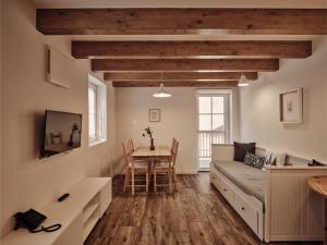 a living room with a couch and a table at Guesthouse Odle in Funes