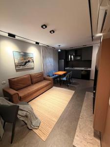 a living room with a couch and a table at Casa Del Sol 2 - Shengjin in Shëngjin