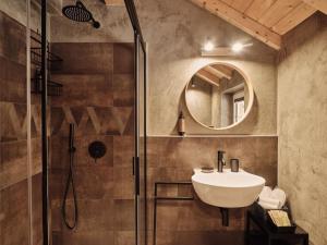 a bathroom with a shower and a sink and a mirror at Guesthouse Odle in Funes +45 photos