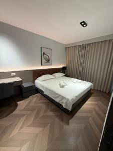 a bedroom with a large bed and a desk at Casa Del Sol 2 - Shengjin in Shëngjin
