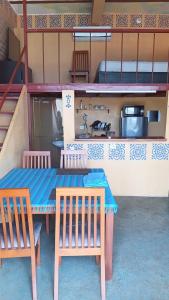 a table and chairs in a room with a bunk bed at Buena Vista in Taganga