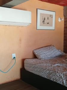 a bedroom with a bed and a light on the wall at Buena Vista in Taganga +1 photo