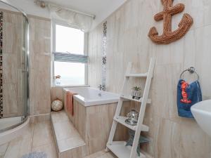 a bathroom with a ladder next to a sink and a bath tub at The View in Criccieth +44 photos