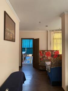 a living room with a couch and a door at Corps-A in Almaty