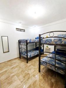 a room with three bunk beds in it at Casa Los Reyes in La Magdalena Atlipac