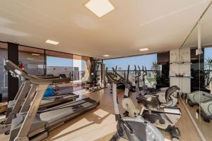 a gym with treadmills and elliptical machines at Flipchave | Highline design in Joinville