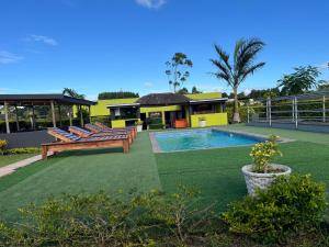 a backyard with a swimming pool and a house at Mbizana Lifestyle in Monzi