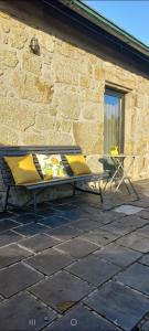 a bench sitting on a patio next to a building at Casa do Fundão in Paredes