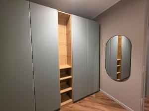 a dressing room with a mirror and a closet at Gravina Boutique Apartment in Gravina in Puglia