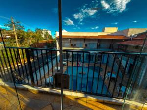 a balcony with a view of a swimming pool at Hotel Picadão in São Pedro