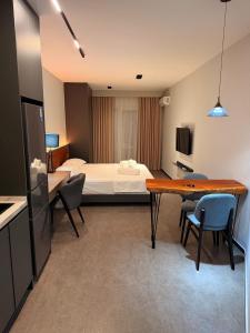 a hotel room with a bed and a table and chairs at Casa Del Sol Studio - Shengjin in Shëngjin