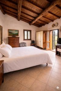 a bedroom with a large white bed in a room at Casa del Borgo, between Mountains and Lake, Near Rome in Canepina
