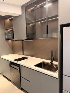 a kitchen with a sink and a counter top at Casa Del Sol Studio - Shengjin in Shëngjin