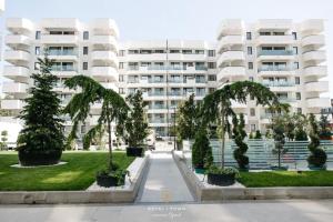 an apartment building with trees in front of it at Fancy Bonjour - modern apartment in Iaşi