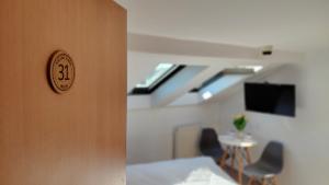 a room with a door with a bed and a table at Noclegi Flauta in Mielno