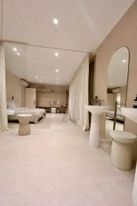a large room with a bed and a bedroom with tables at KIKO Luxury Lifestyle in Zadar